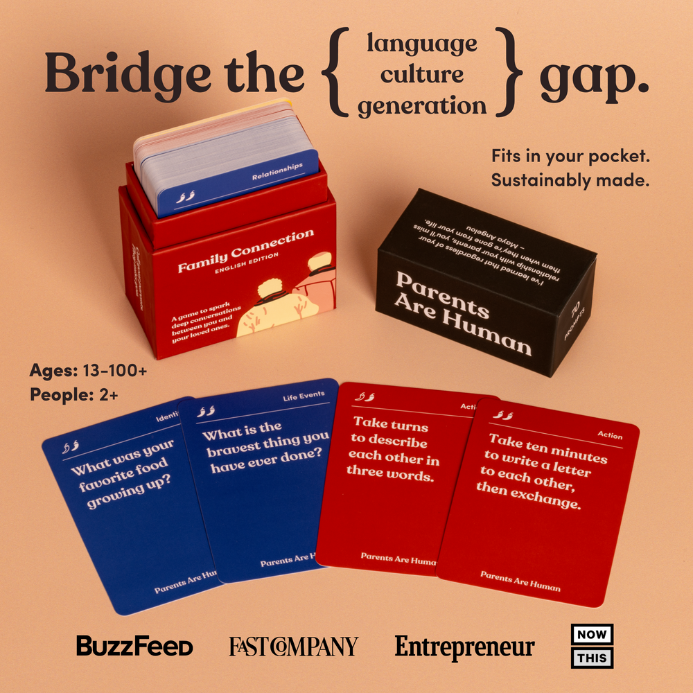 An open Parents Are Human Family Connection box, English Edition, beside four fanned cards on a peach background