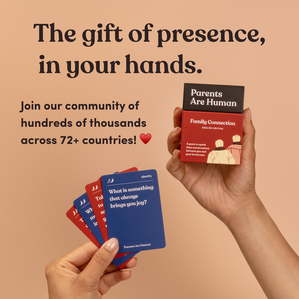 A hand holding fanned question cards and another hand holding a Parents Are Human box, headline “The gift of presence, in your hands”