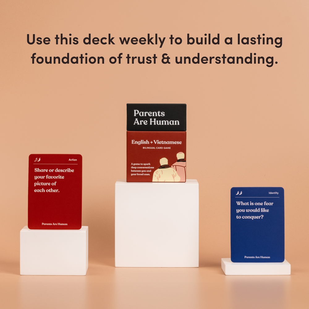 Parents Are Human English + Vietnamese box on a pedestal between two cards, tan background