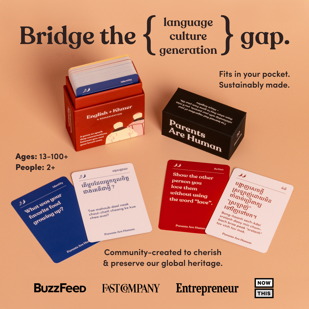 An open Parents Are Human English + Khmer box beside four fanned bilingual cards on a peach background