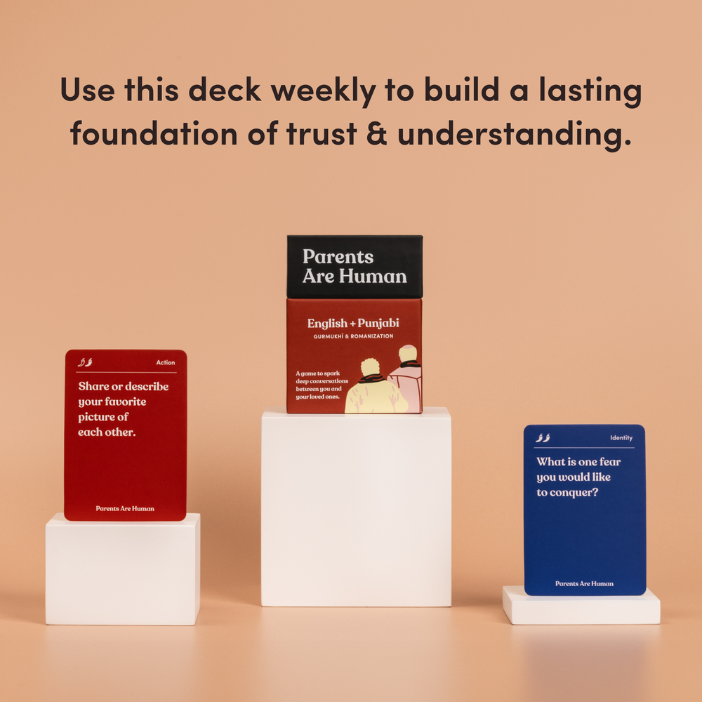 Parents Are Human English + Punjabi box on a pedestal between two cards, tan background