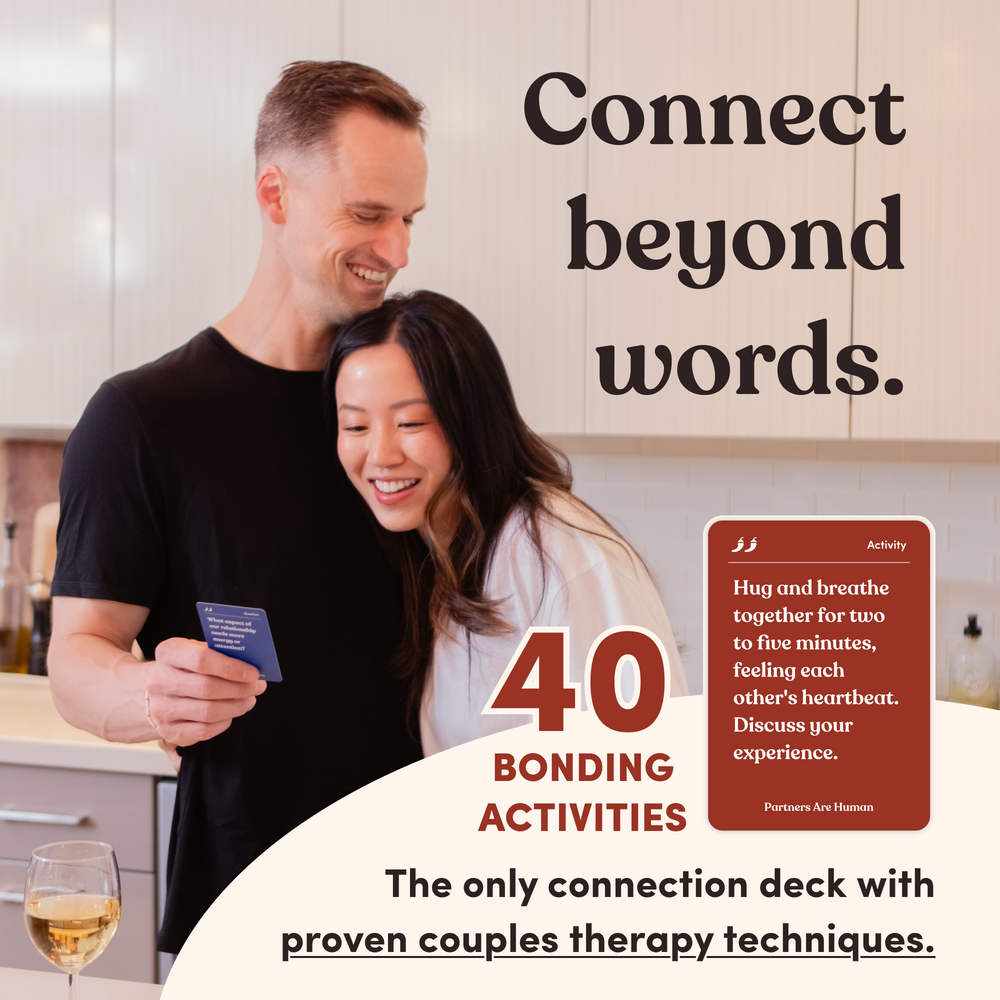 A couple laughing in a kitchen beside a Partners Are Human activity card, headline “Connect beyond words”