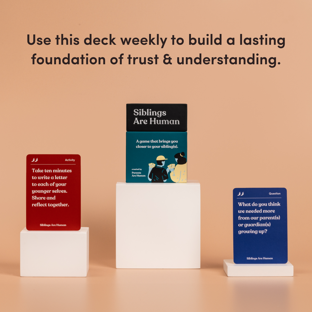 Siblings Are Human box on a pedestal between a red activity card and a blue question card, on a peach background