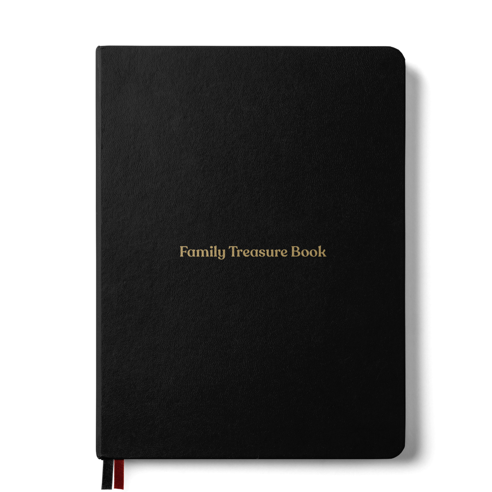 Family Treasure Book, a black hardcover book with a gold foil title and a red ribbon bookmark